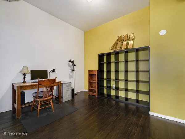 a view of a workspace with furniture and wooden floor
