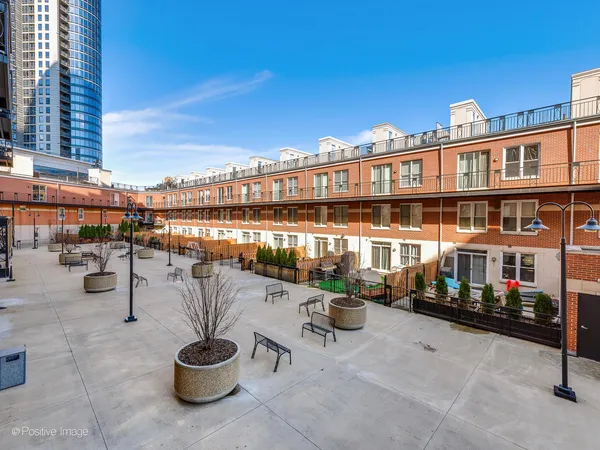 a city view with tall buildings and a bench