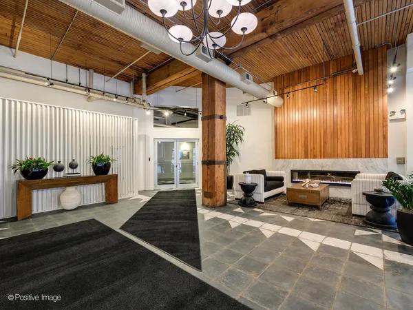 a lobby with furniture and potted plants