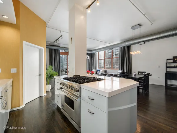a kitchen with stainless steel appliances granite countertop a stove and a sink