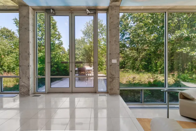 a bedroom with a bed and a view of balcony