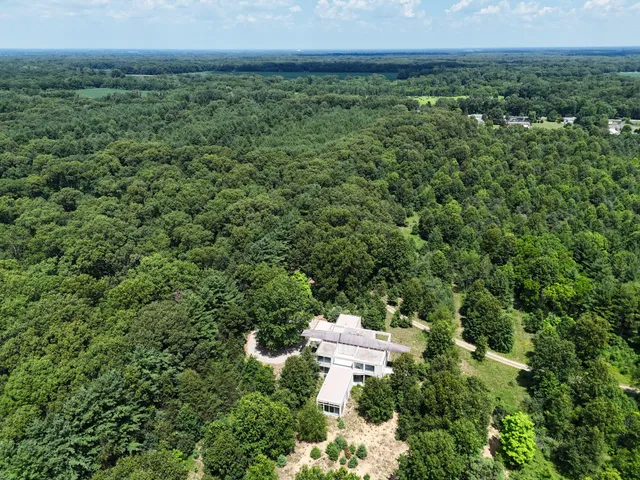 a view of staircase with a floor to ceiling window and wooden floor