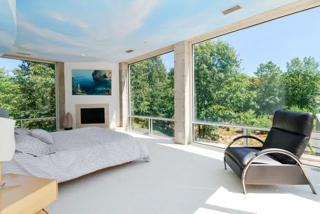 a aerial view of a house with a yard balcony and furniture