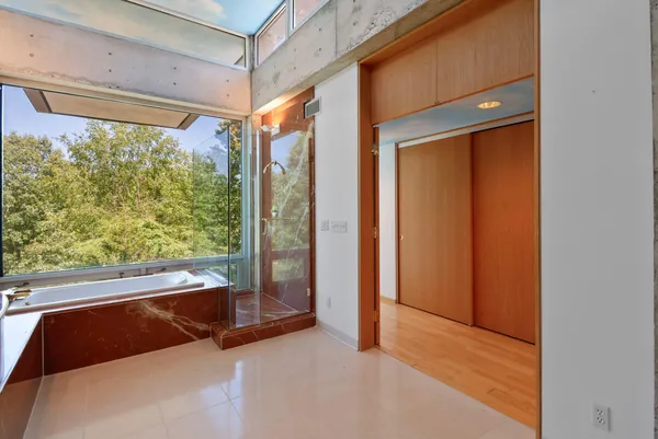 a front view of a house with a yard and trees