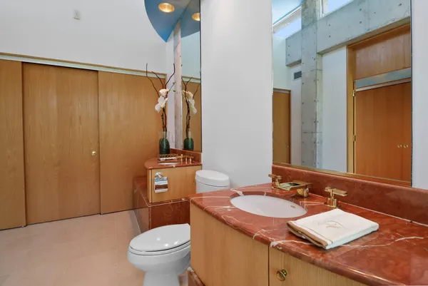 an aerial view of a house with a yard and tree s