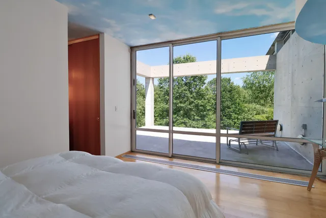 an aerial view of residential house with outdoor space and trees all around