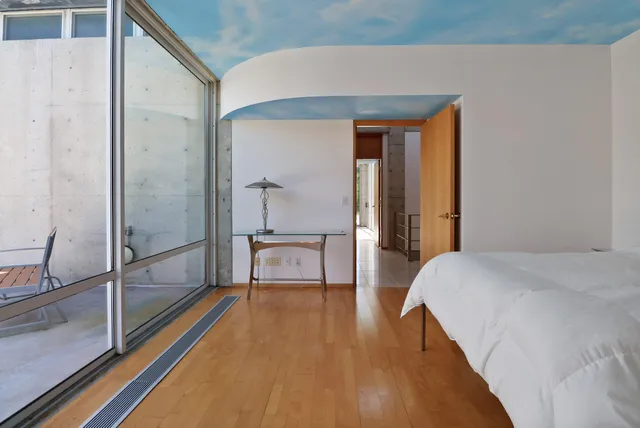 an aerial view of residential house with outdoor space and trees all around