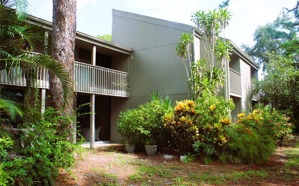 a front view of multi story residential apartment building with yard and green space
