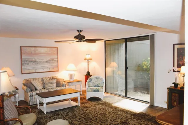 a living room with furniture and a floor to ceiling window