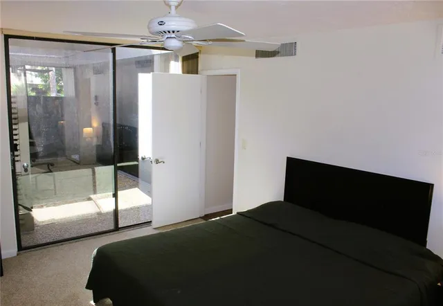 a bedroom with a bed and a glass door