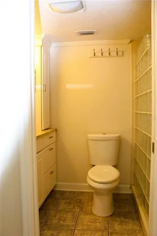 a bathroom with a toilet and a shower