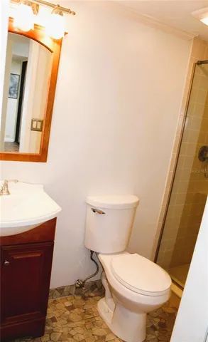 a white toilet sitting next to a bathroom sink