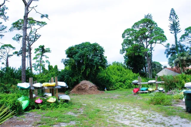 a view of a house with backyard sitting area and garden
