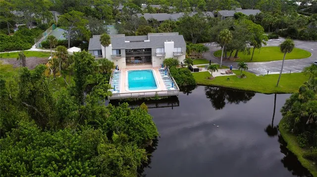 an aerial view of a house with a yard basket ball court and outdoor seating