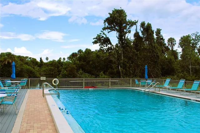 swimming view of house with outdoor space and sitting area