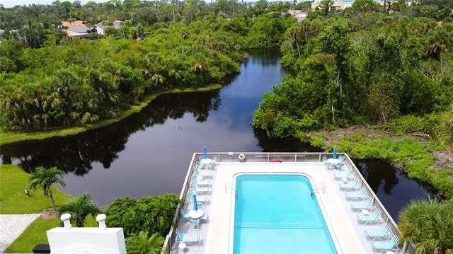 an aerial view of house with yard and outdoor seating