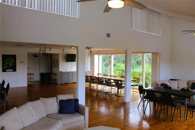 a living room with furniture dining table and a large window