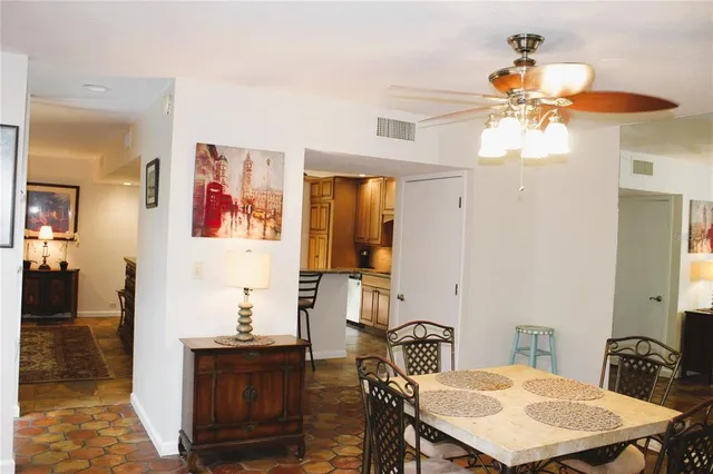 a view of a dining room with furniture and chandelier
