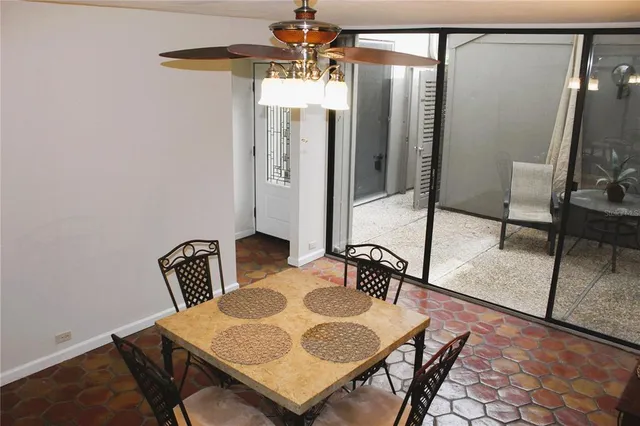 a view of a dining room with furniture and a chandelier