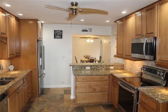 a kitchen with a sink stove and refrigerator