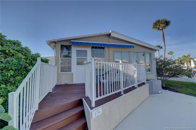 a view of a house with wooden fence