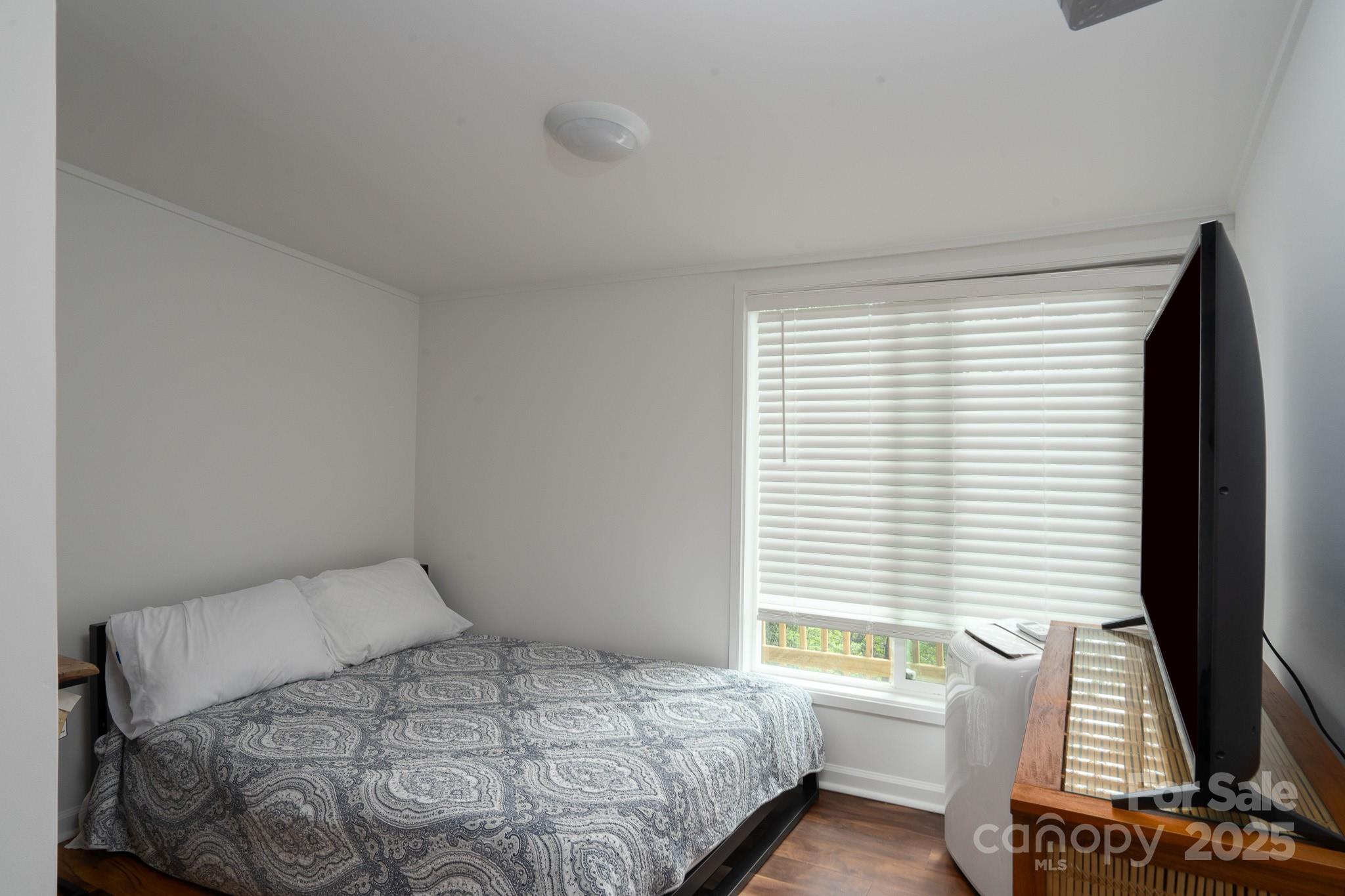 2066 Marquesas Avenue Fort Mill, SC 29708 - Photo 37 of 45 a bedroom with a bed and a flat screen tv