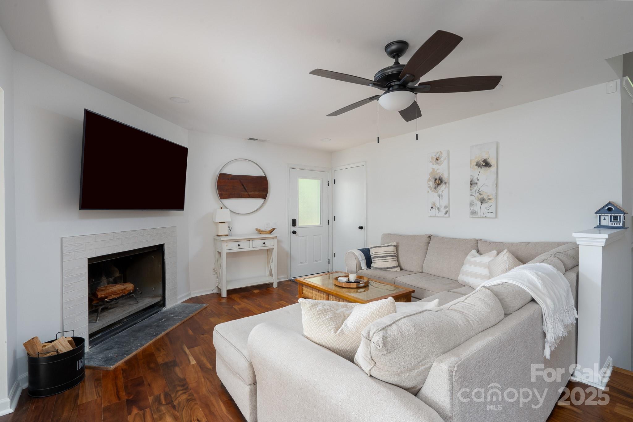 2066 Marquesas Avenue Fort Mill, SC 29708 - Photo 8 of 45 a living room with furniture a fireplace and a flat screen tv