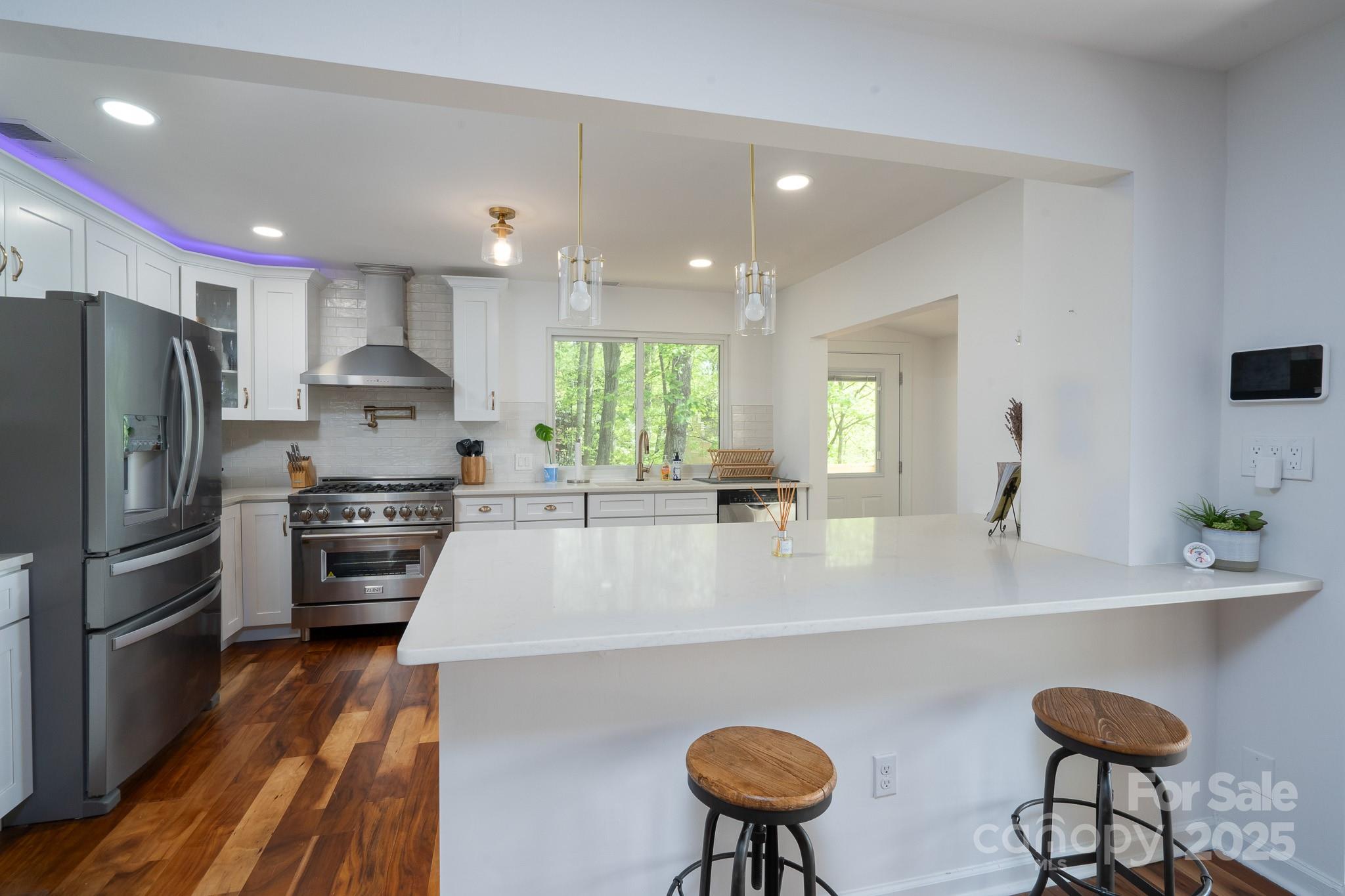 2066 Marquesas Avenue Fort Mill, SC 29708 - Photo 10 of 45 a large kitchen with kitchen island a large counter top space a sink stainless steel appliances and cabinets