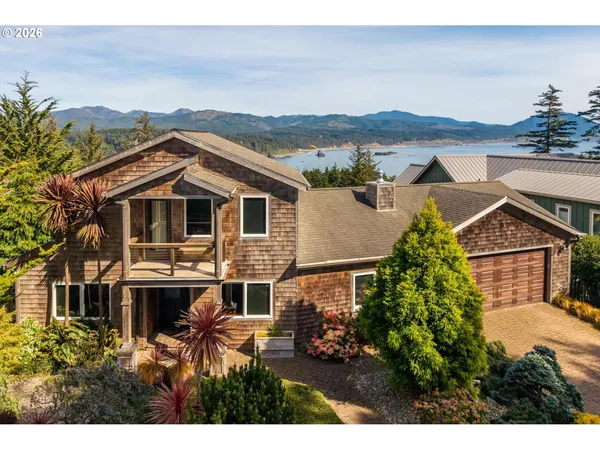 a front view of a house with a yard and balcony