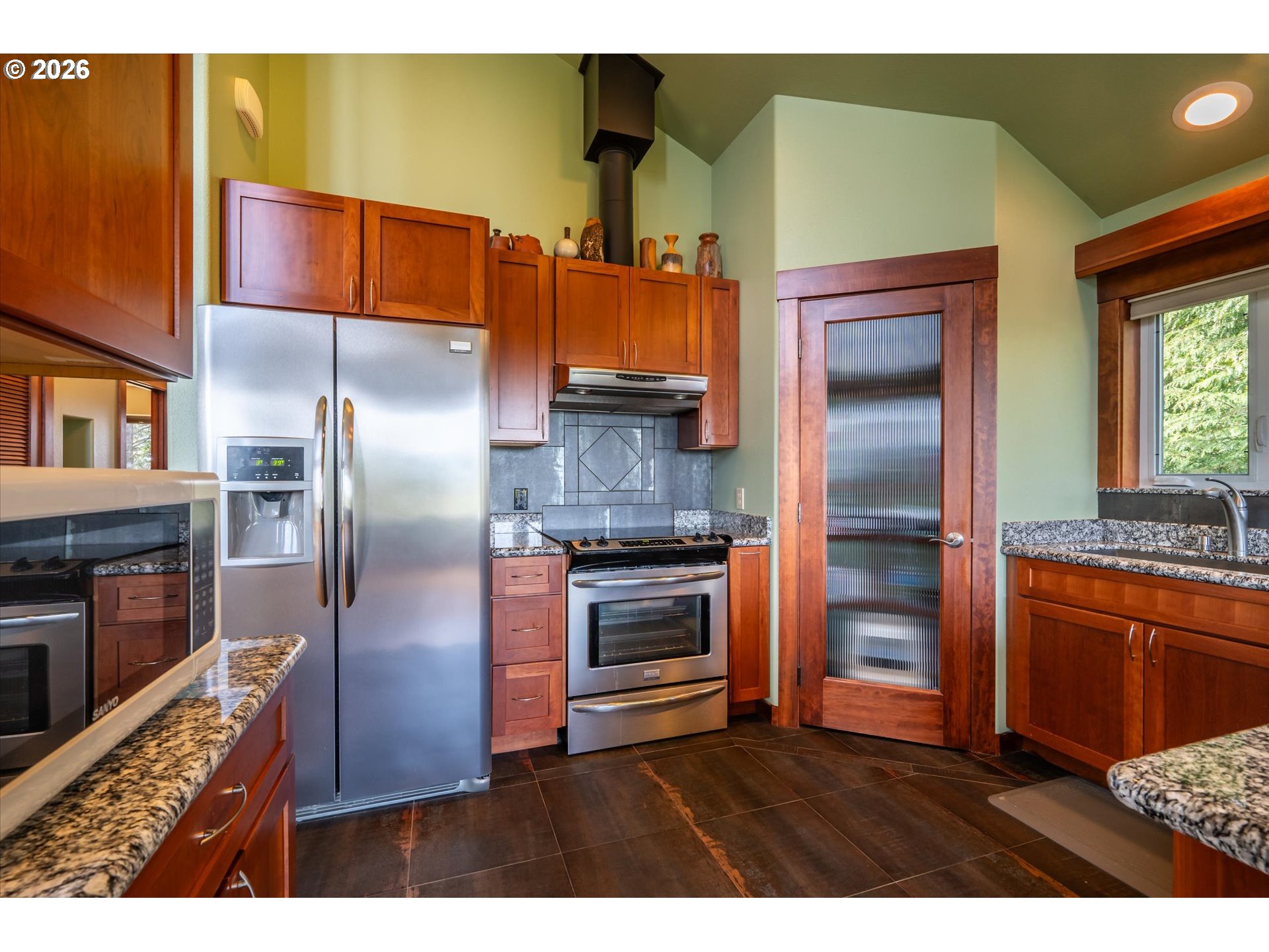 650 Tichenor Cemetery Road Port Orford, OR 97465 - Photo 11 of 48 a kitchen with stainless steel appliances granite countertop a refrigerator and a stove