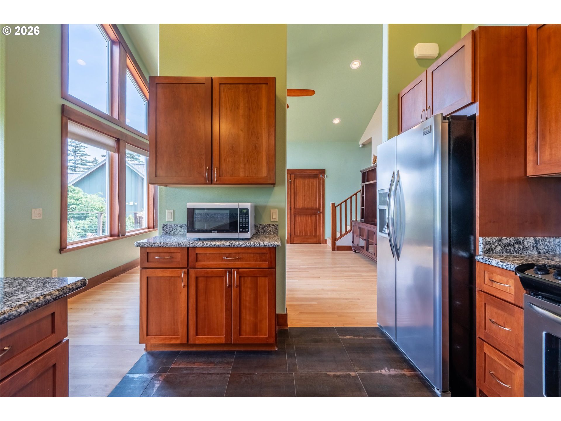 650 Tichenor Cemetery Road Port Orford, OR 97465 - Photo 14 of 48 a kitchen with stainless steel appliances granite countertop a refrigerator a stove top oven and a sink