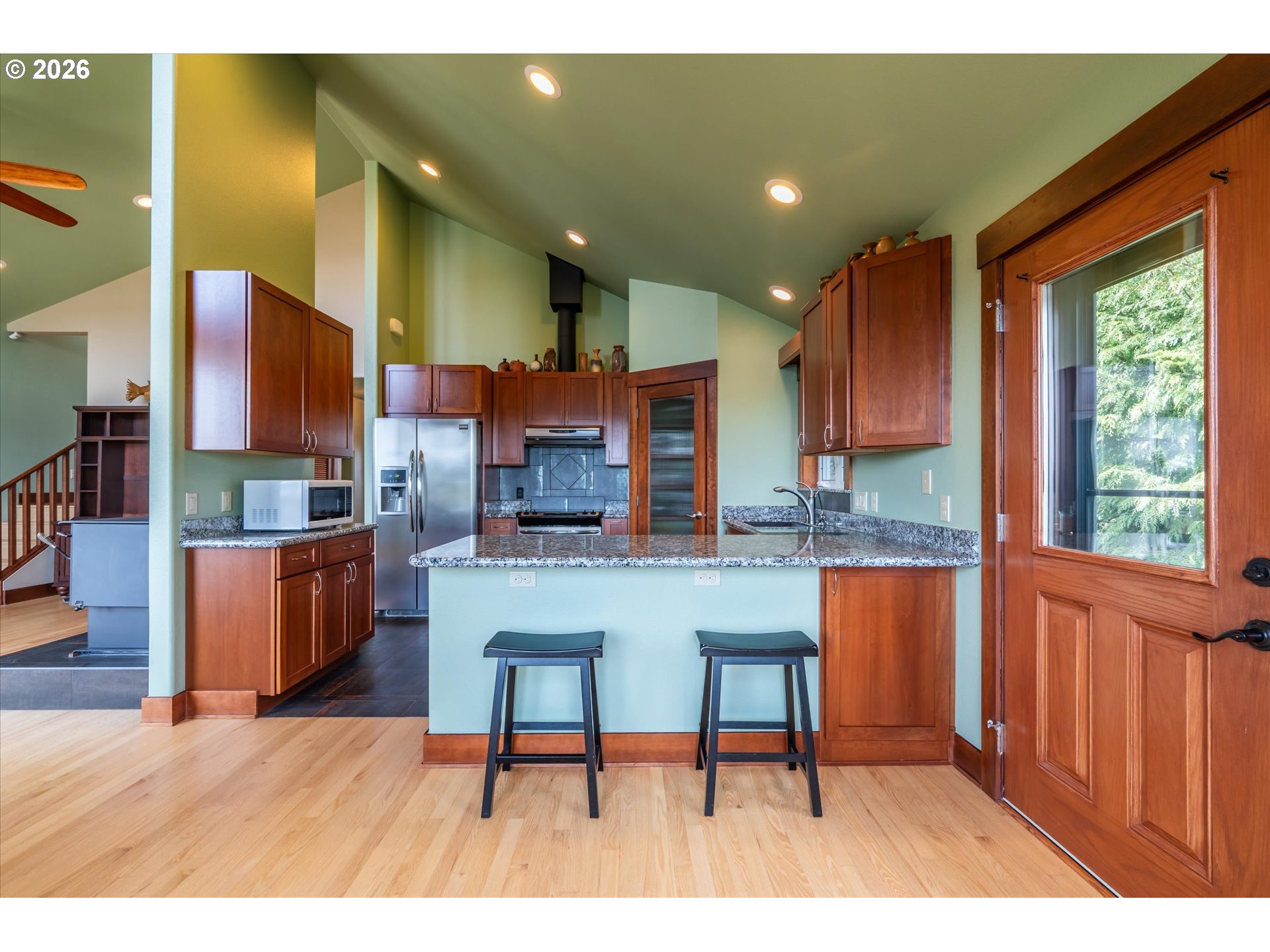 650 Tichenor Cemetery Road Port Orford, OR 97465 - Photo 16 of 48 a living room with stainless steel appliances kitchen island granite countertop furniture and a wooden floor