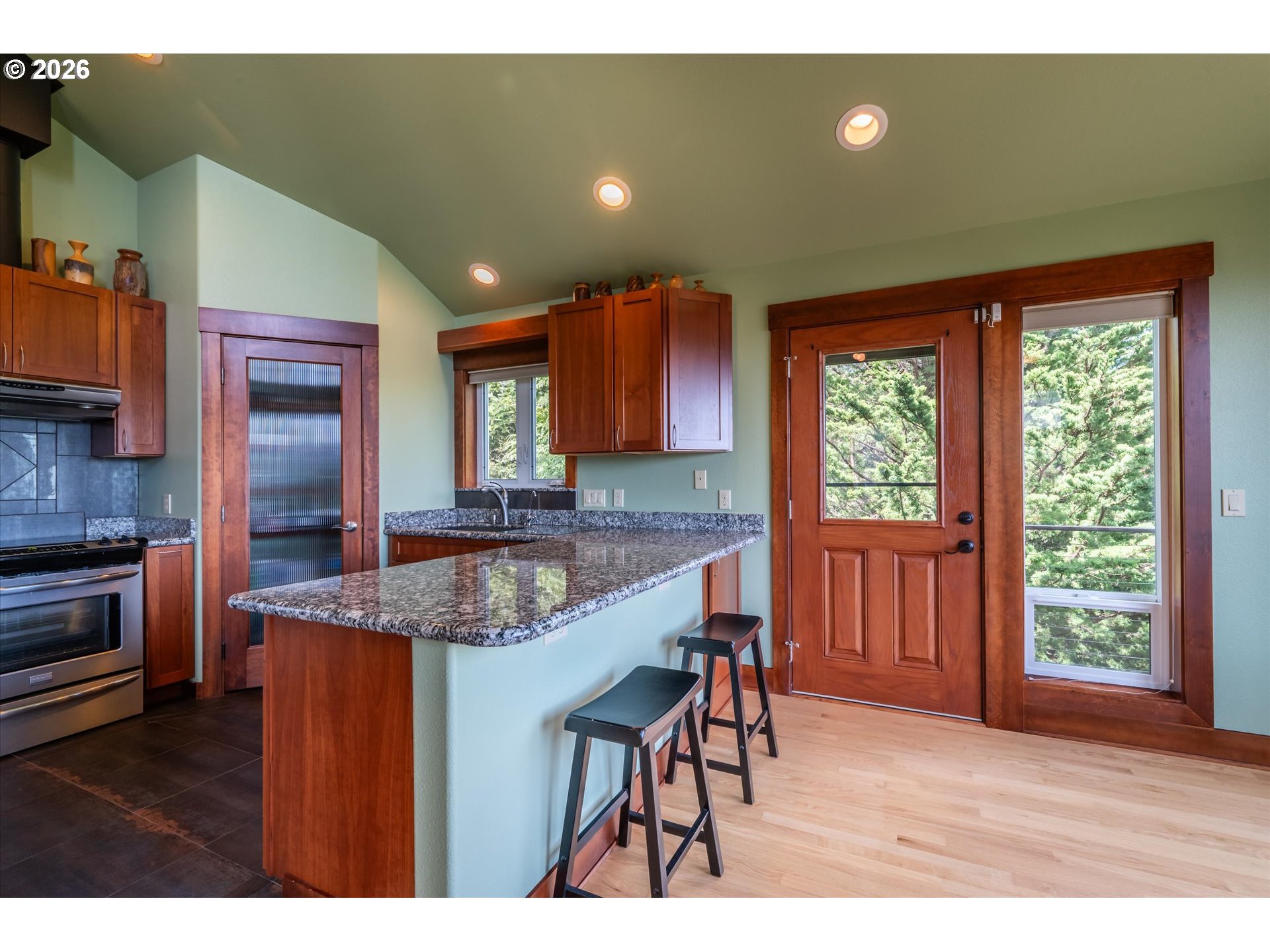 650 Tichenor Cemetery Road Port Orford, OR 97465 - Photo 17 of 48 a kitchen with stainless steel appliances granite countertop counter space a sink and cabinets