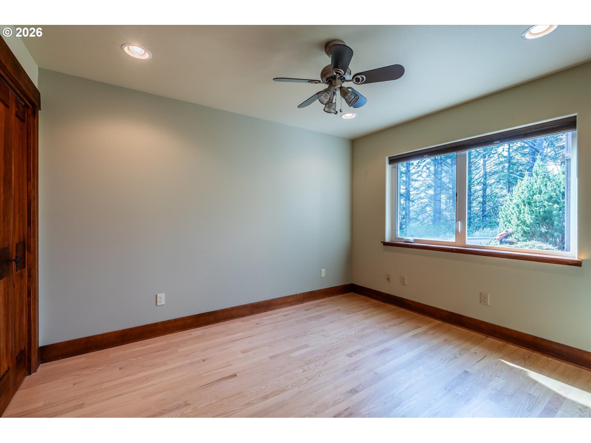 650 Tichenor Cemetery Road Port Orford, OR 97465 - Photo 27 of 48 a view of an empty room with a window and wooden floor