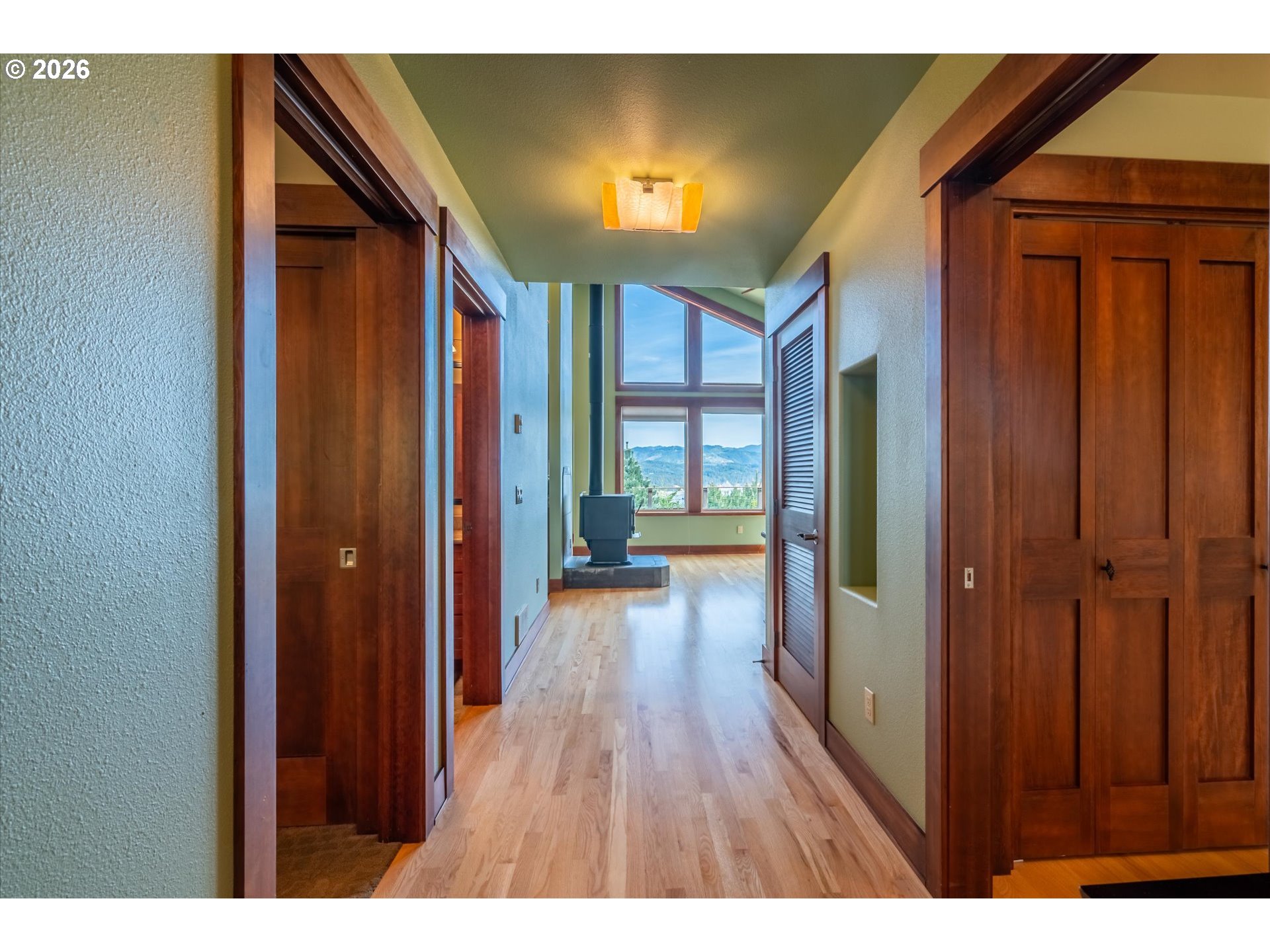 650 Tichenor Cemetery Road Port Orford, OR 97465 - Photo 29 of 48 a hallway with wooden floor closet and a bathroom