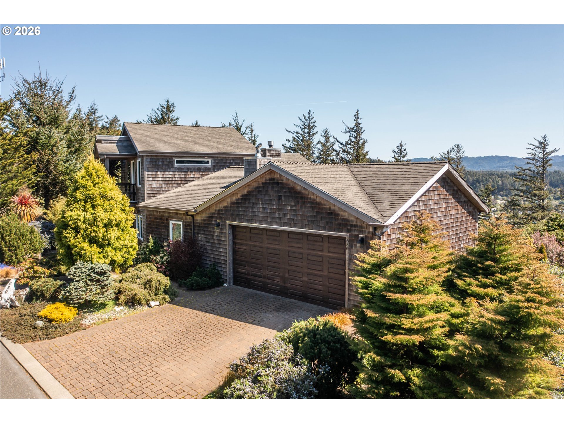 650 Tichenor Cemetery Road Port Orford, OR 97465 - Photo 41 of 48 a view of a house with a small yard and potted plants