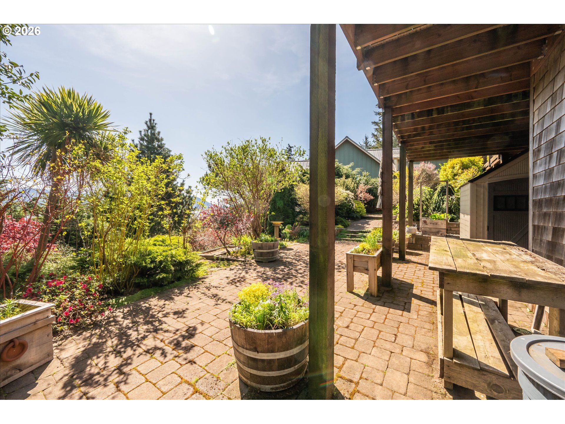 650 Tichenor Cemetery Road Port Orford, OR 97465 - Photo 43 of 48 a view of a patio with table and chairs and potted plants
