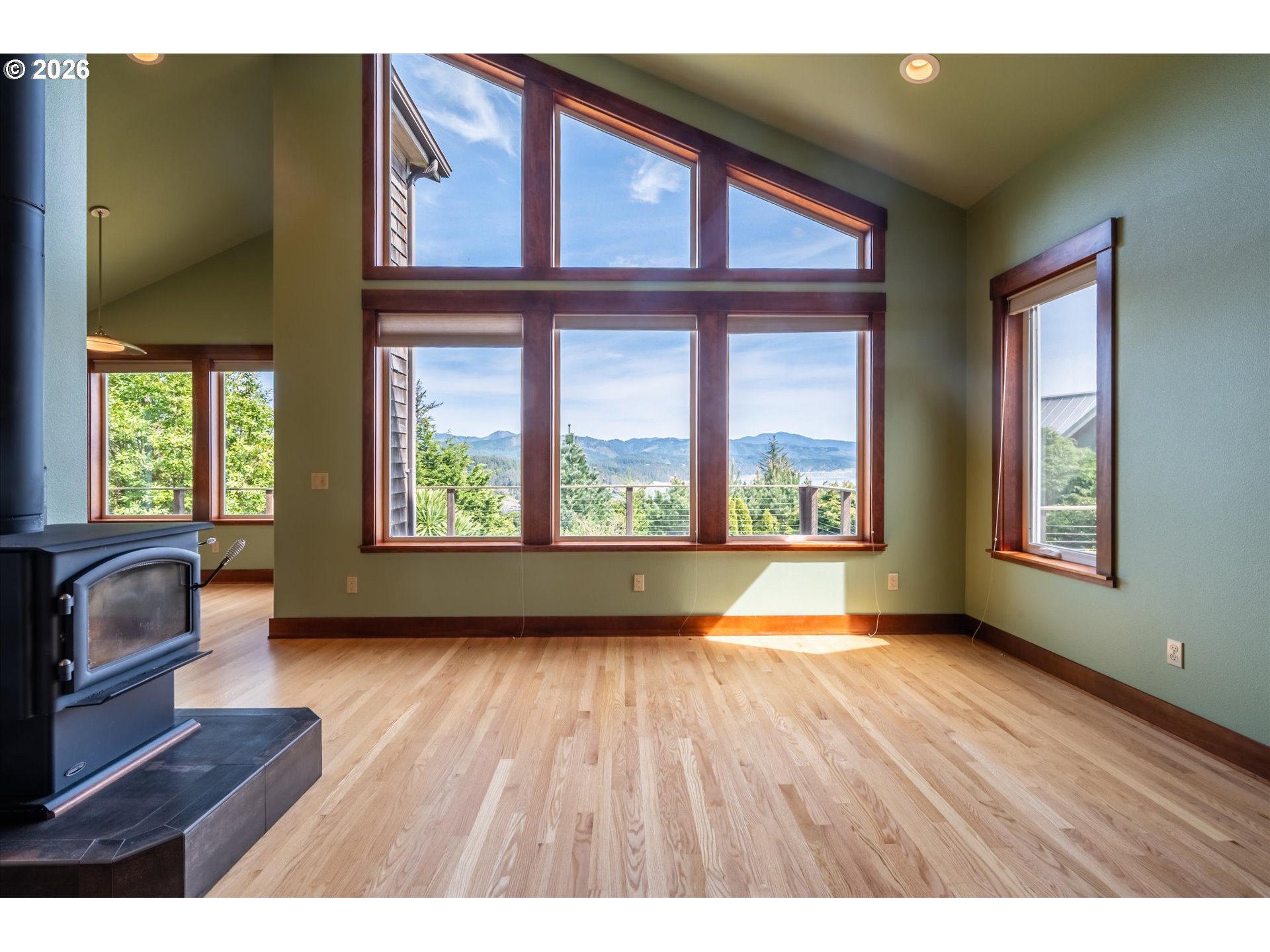 650 Tichenor Cemetery Road Port Orford, OR 97465 - Photo 7 of 48 a view of an empty room with a window and wooden floor
