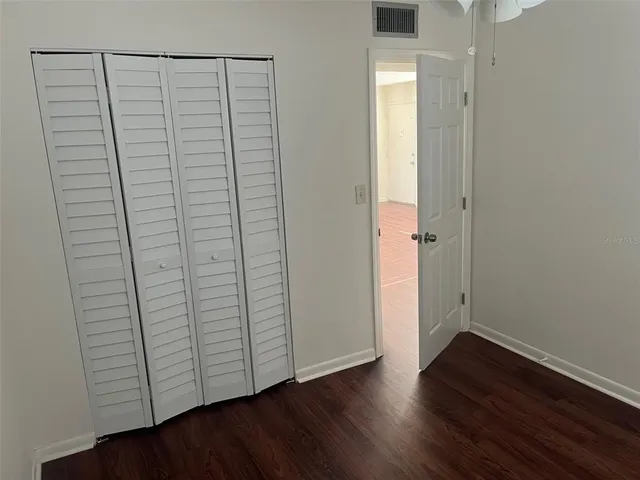 an empty room with wooden floor