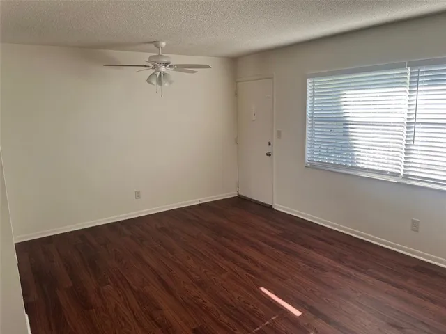 a view of a room with wooden floor and window