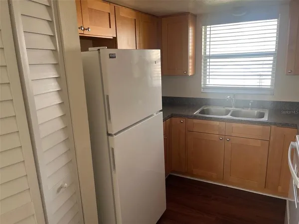 a white refrigerator freezer sitting inside of a kitchen