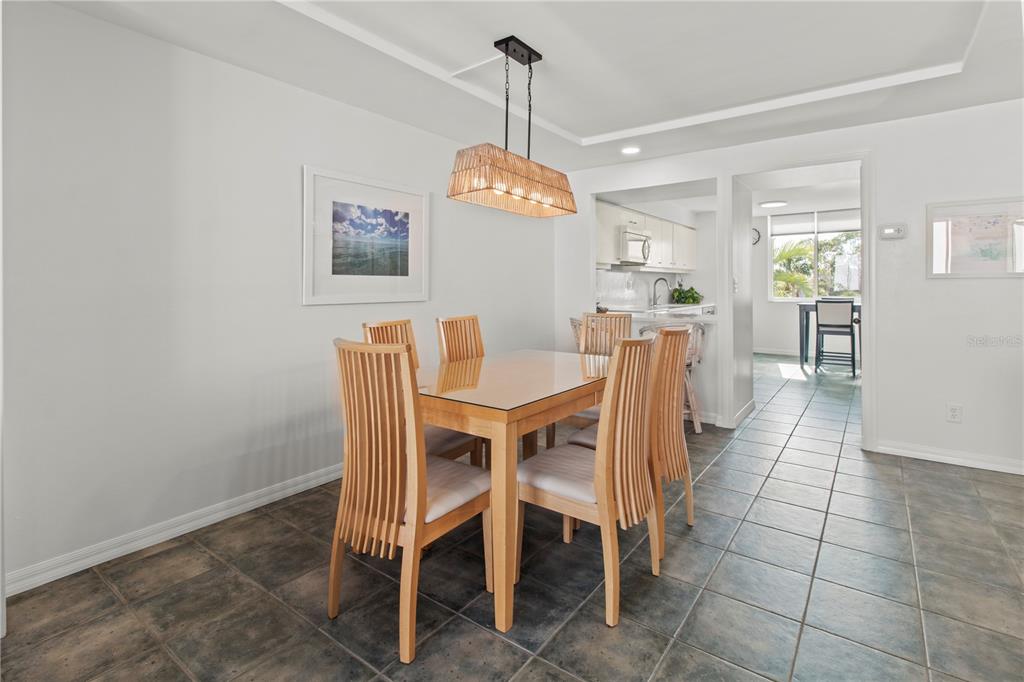 829 Bayport Way, Unit 829 Longboat Key, FL 34228 - Photo 13 of 58 a dining room with furniture and window