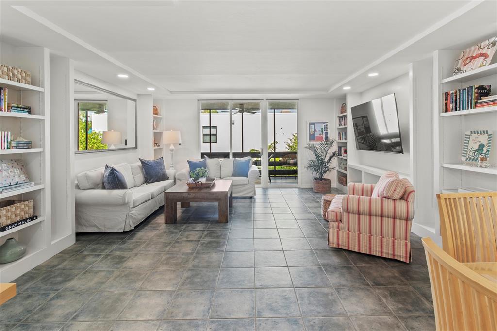 829 Bayport Way, Unit 829 Longboat Key, FL 34228 - Photo 14 of 58 a living room with furniture and a flat screen tv