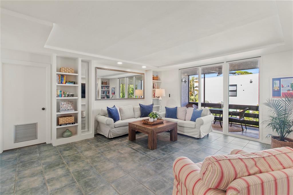 829 Bayport Way, Unit 829 Longboat Key, FL 34228 - Photo 15 of 58 a living room with furniture and a large window