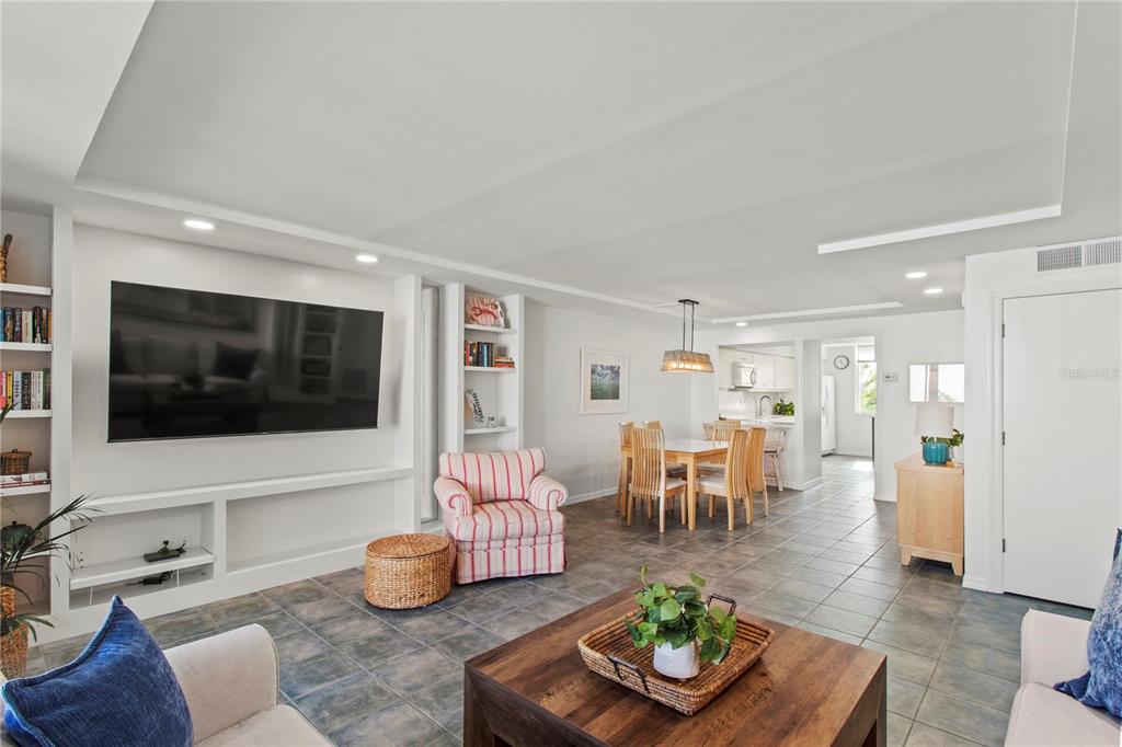 829 Bayport Way, Unit 829 Longboat Key, FL 34228 - Photo 17 of 58 a living room with furniture and a flat screen tv
