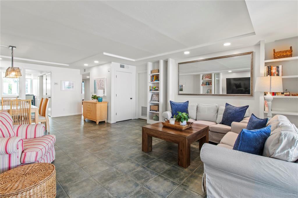829 Bayport Way, Unit 829 Longboat Key, FL 34228 - Photo 18 of 58 a living room with furniture and a flat screen tv