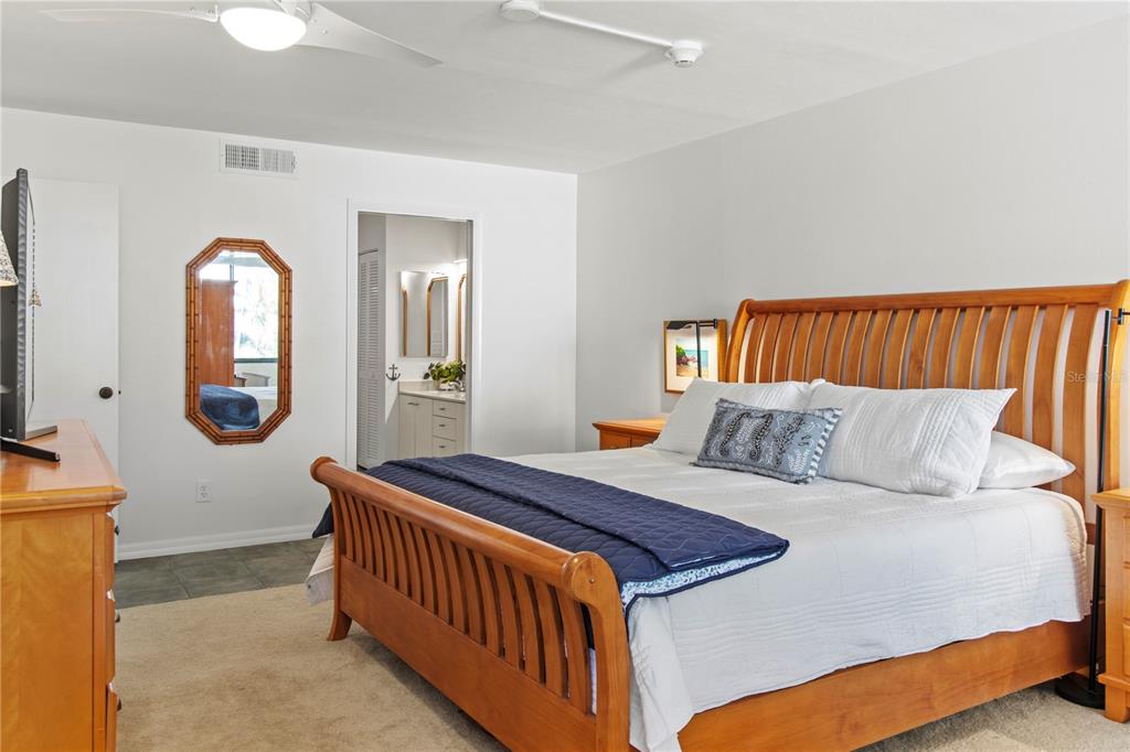 829 Bayport Way, Unit 829 Longboat Key, FL 34228 - Photo 22 of 58 a bed room with a bed and a mirror