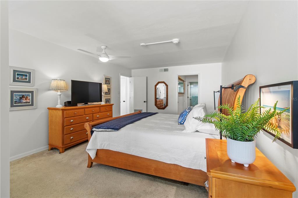 829 Bayport Way, Unit 829 Longboat Key, FL 34228 - Photo 23 of 58 a bedroom with furniture and flat screen tv