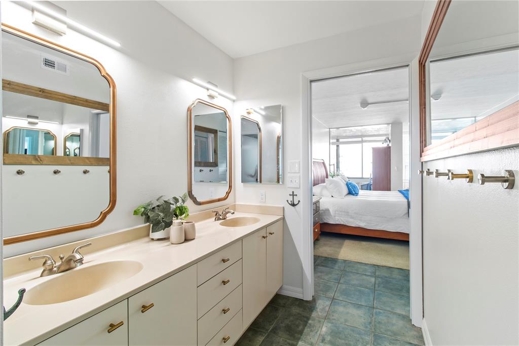 829 Bayport Way, Unit 829 Longboat Key, FL 34228 - Photo 25 of 58 a en suite bathroom with double sink and a mirror