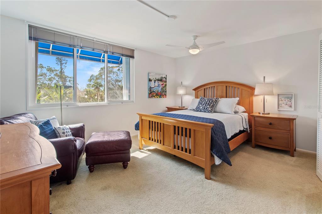 829 Bayport Way, Unit 829 Longboat Key, FL 34228 - Photo 26 of 58 a bedroom with a bed table and a window